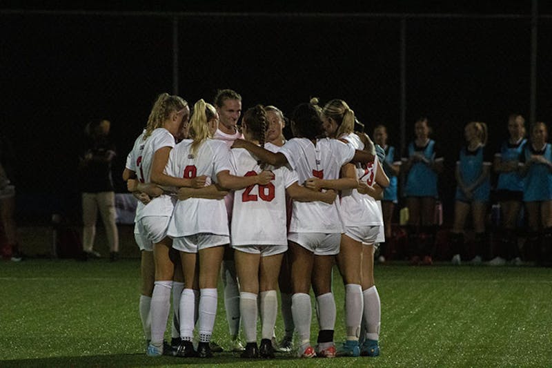 The team has a huddle before the first game of the season against Frostburg.