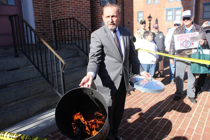 Gene Still displays a burning Confederate-Nazi flag to the crowd gathered outside of the Adams County Courthouse in Gettysburg on Nov. 17.