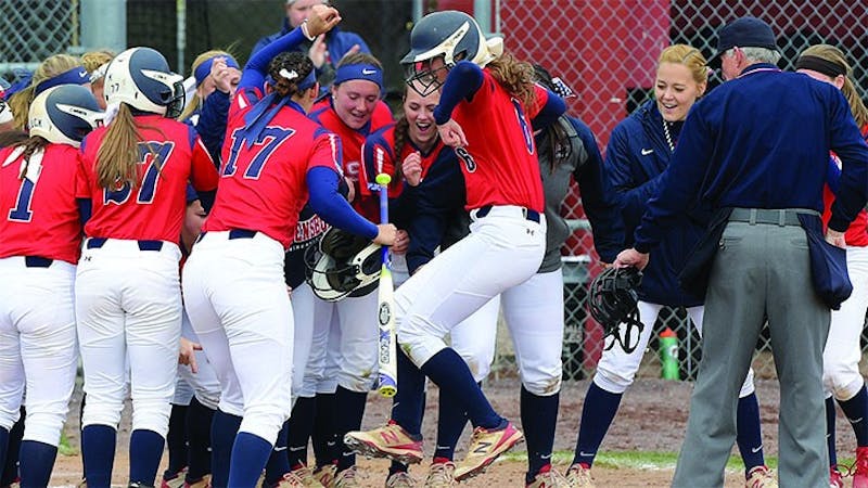 SU’s Tara Bicko touches home plate after hitting a three-run home run in Game 1 on Saturday.