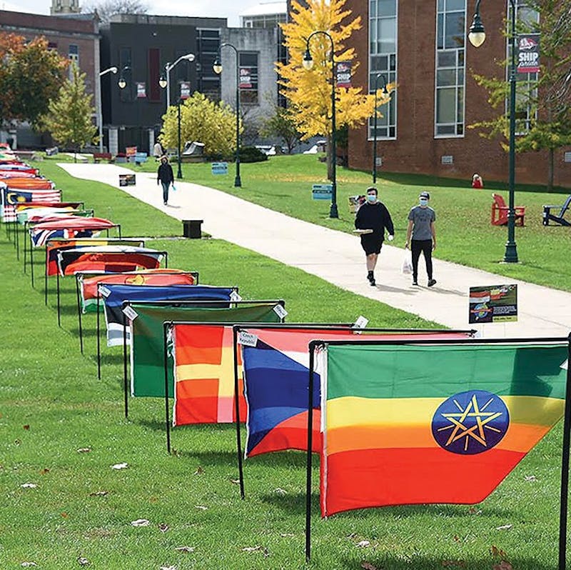 The international flag display is set up in the academic quad for International Education Week.
