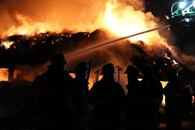 Firefighters work to bring a barn fire under control Wednesday night and early Thursday morning.