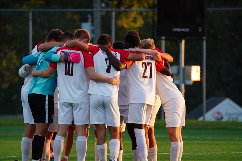 The men's soccer team has a team huddle before its match against Shepherd University on Sept. 27.
