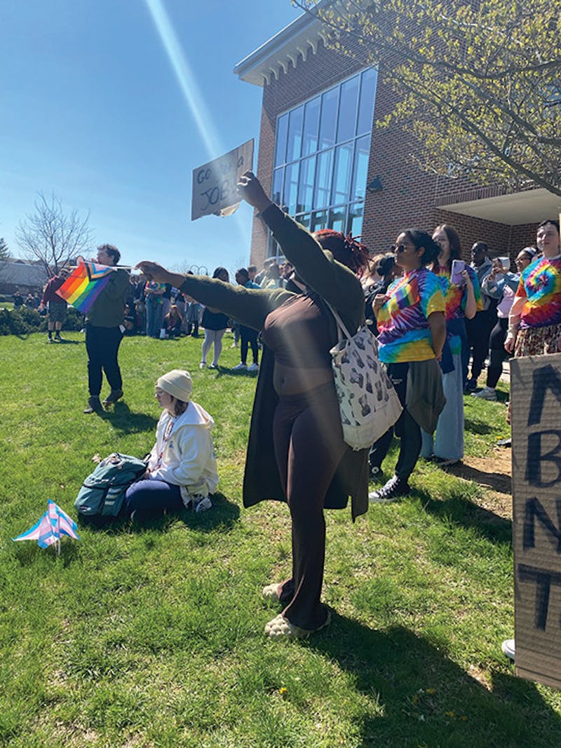 A crowd of students wave pride flags in protest against the controversial visiting religious group.