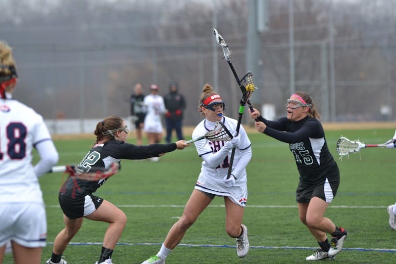 	Bennett Widlake (middle) fights through two SRU defenders on her way to the goal. 