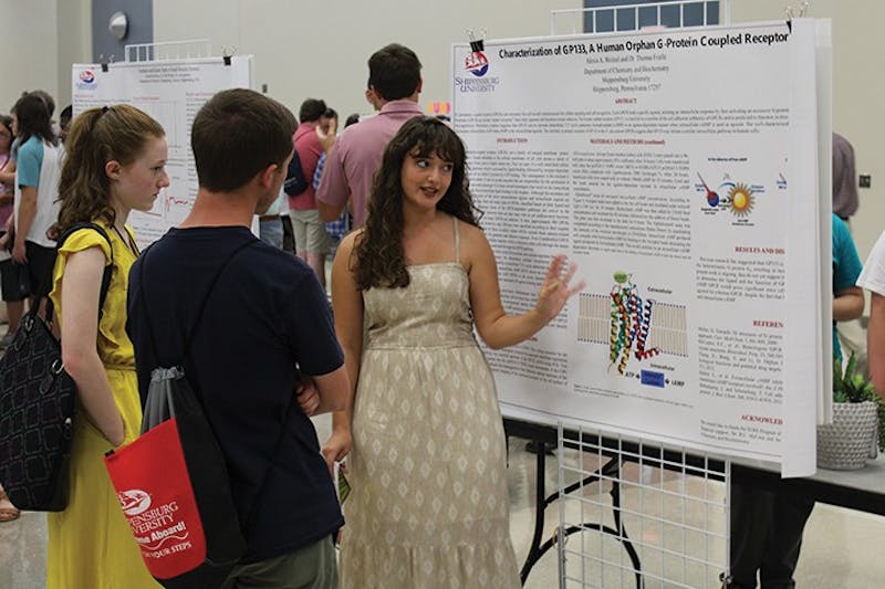 Alexis Weitzel speaks with new  students about her Summer Undergraduate Research Experience (SURE) project. Weitzel studied “Characterization of a Human G protein-coupled receptor.” SURE student and faculty researchers presented Thursday during the Success Now! Expo during fall Welcome Week.