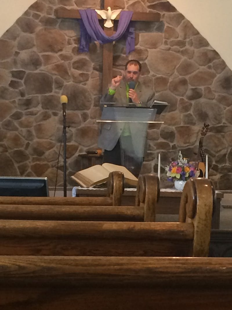 Pastor Christopher Faylor animatedly delivers his sermon at the Big Spring Heights Church of God in Newville, Pennsylvania.