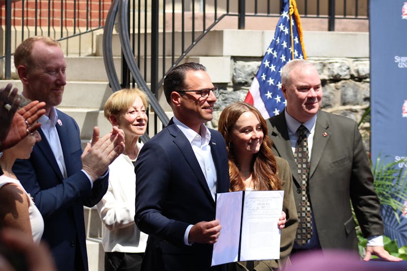 Pennsylvania Governor Josh Shapiro poses with House Bill 897, which he signed in front of Stewart Hall and wrote "Ship -- Keep Showing Us The Way!"