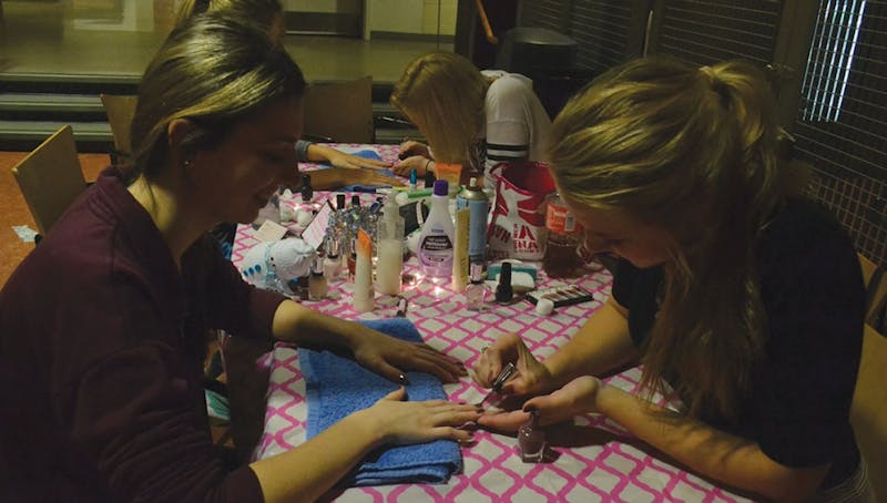 Students get their nails painted in the "Craft Cafe"