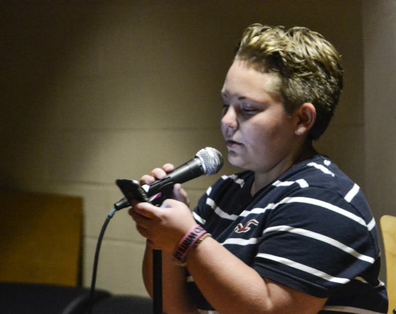 Event organizer Ali Laughman read alongside participants at the first VOICES Poetry Slam event in McFeely’s Coffeehouse.&nbsp;