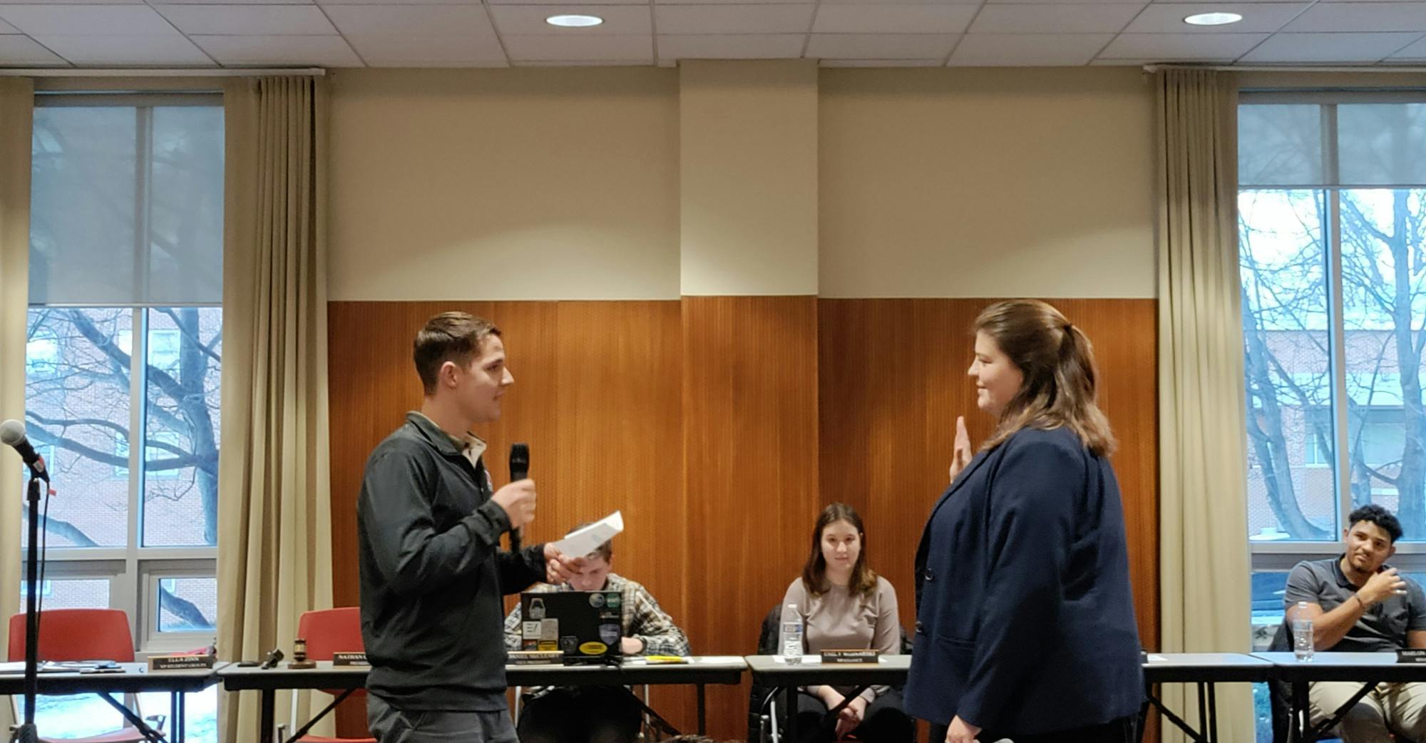 SGA President Nathan Garber swears in Ella Zinn as the next president.