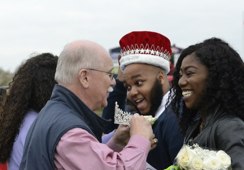 SU President Jody Harpster crowns the king and queen winners, Brandon Christmas-Lindsey and Madeline Kwarteng.