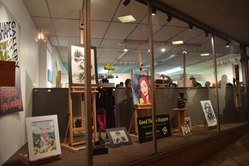 Art is displayed in the front window of the SHAPE Gallery. Shawn Richardson, a founding member, said that the new location on King Street allows passersby to easily observe artwork.