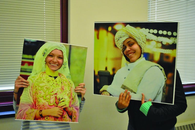 Ali Mowers (left) and Taren Swartz (right) model cutouts representing Middle Eastern culture. Saudi Arabia was a highlighted culture during the event.