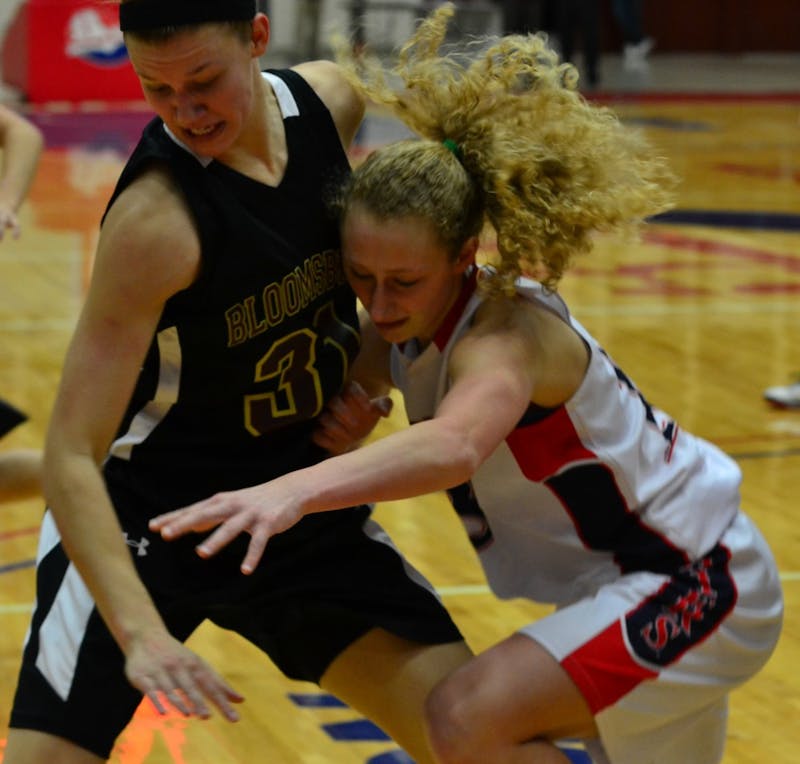 	Caitlyn Deeter scrambles for a loose ball in the first half. Deeter finished the game with 4 points. 