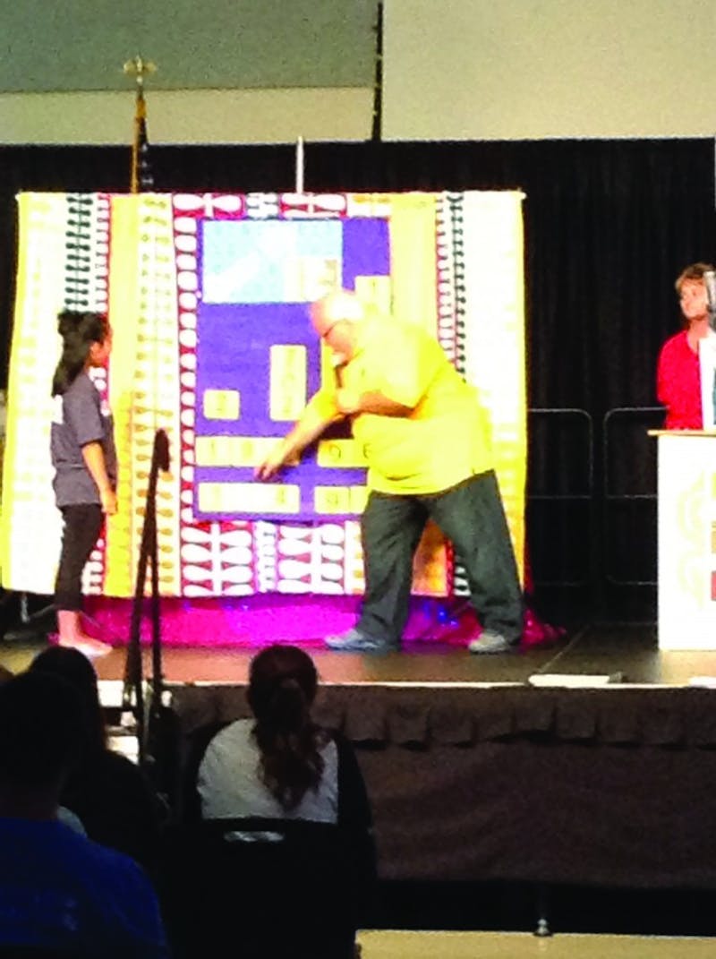Host of Price it Right brings a student onto stage to win a prize and play one of the various games from the show.