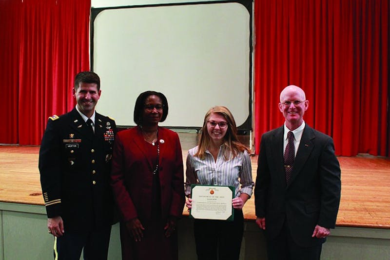 Senior Rachael Rudis was awarded the Commander’s Award for Public Service during the Veteran’s Day ceremony. Pictured from left to right are Lt. Col Christopher Morton, SU President Laurie Carter, Rudis and SU political science Professor James Greenburg.