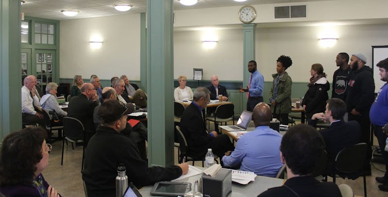 Fitzgerald and Lewis (farthest left,standing) address the SU president’s cabinet members.