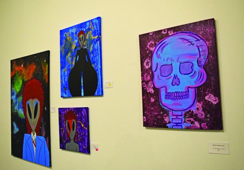 Three paintings of David Bowie-inspired aliens were displayed next to “Electric Skeleton Land.”