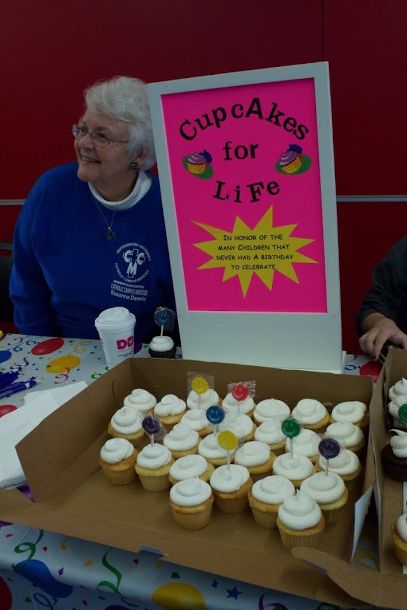 Roxanne Dennis, an SU Catholic campus minister, gives away free cupcakes to spread the pro-life message.