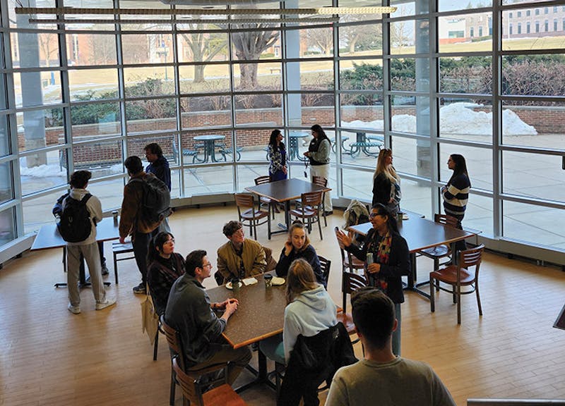 Students and faculty in the College of Arts and Sciences enjoying conversation during a social hour.&nbsp;