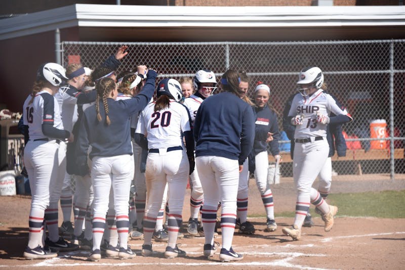 SU's softball team comes together at home plate to celebrate junior Courtney Coy's home run in a game last season. 