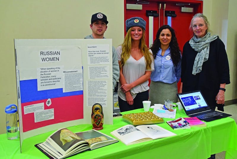 Tyler Murkley, Hayley Ream, Amanda Vazquez and SU professor Catherine B. Clay host a table from the International Studies Department to teach about women in Russia.