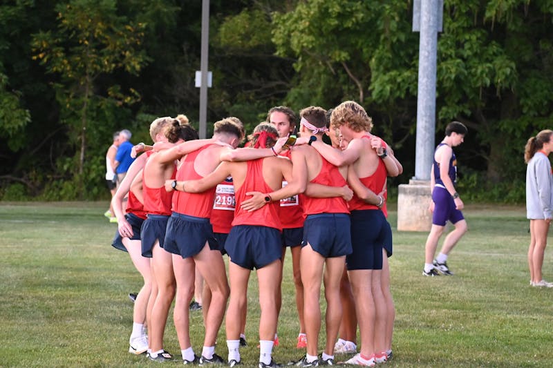 The men's cross country team prepares for the start of their race.