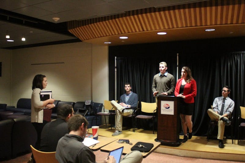 Chris Windbeck and Crystal Hartman stand at the podium and answer questions from Tracie Moyer (right).