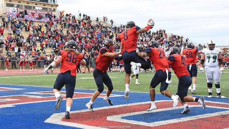 The Red Raiders celebrate after defensive end Richard Nase recovers a bad snap in Slippery Rock’s end zone for the go-ahead score in the game’s final minute.