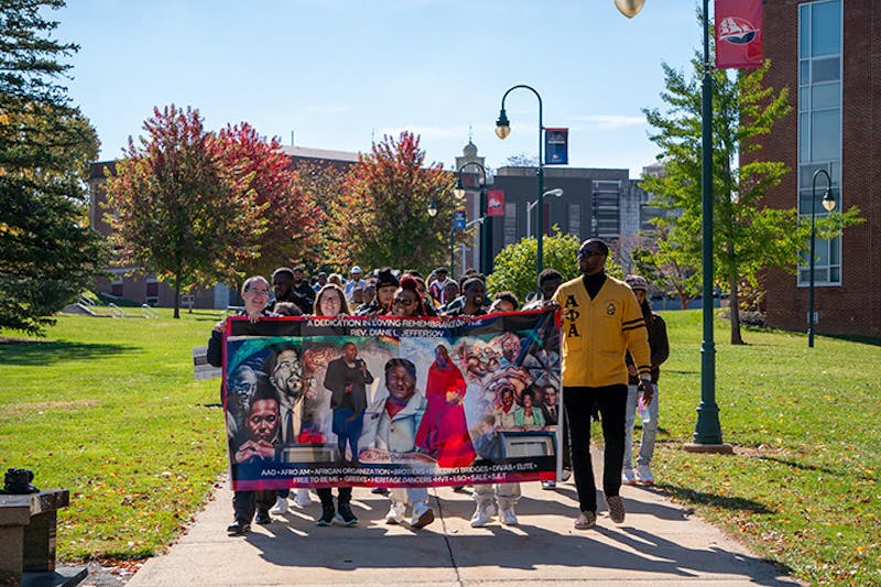 The “March in Remembrance” makes its way across the quad toward the CUB. Students and alumni joined MSA in the march.