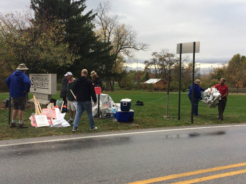 Faculty pack up their signs and supplies on Fogelsanger Road and Burd Run Drive.