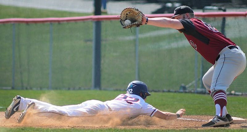 Second baseman Nick Spangler, left, slides back into first base after a pickoff attempt. Spangler recorded at least one hit in three of the Raiders’ four games.