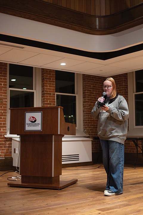 Associate Editor of The Reflector Emily Brewer reading her poem at the Self-Love Soirée.&nbsp;