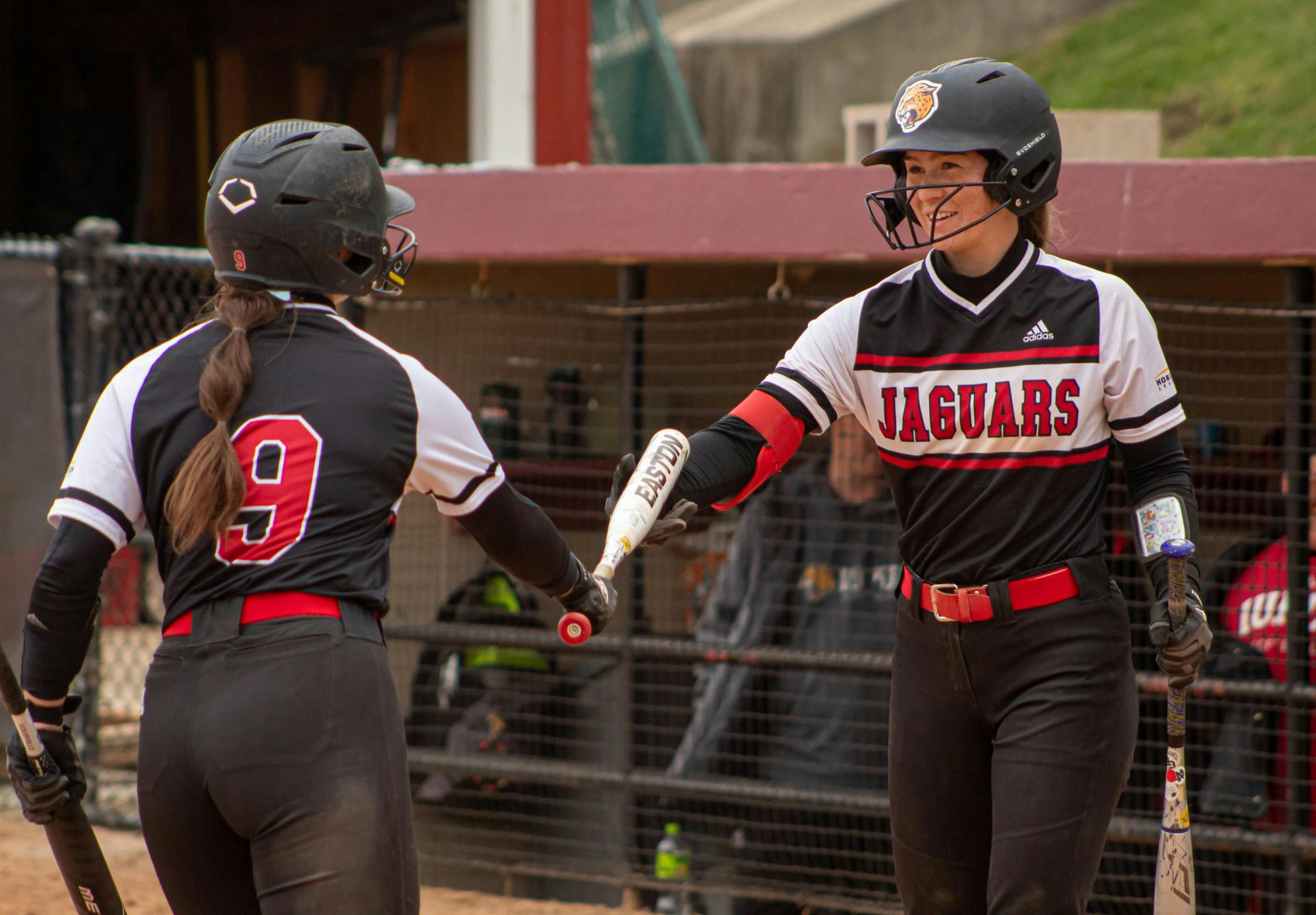 Victoria Sivert Hands off Bat to Kasie Keyes