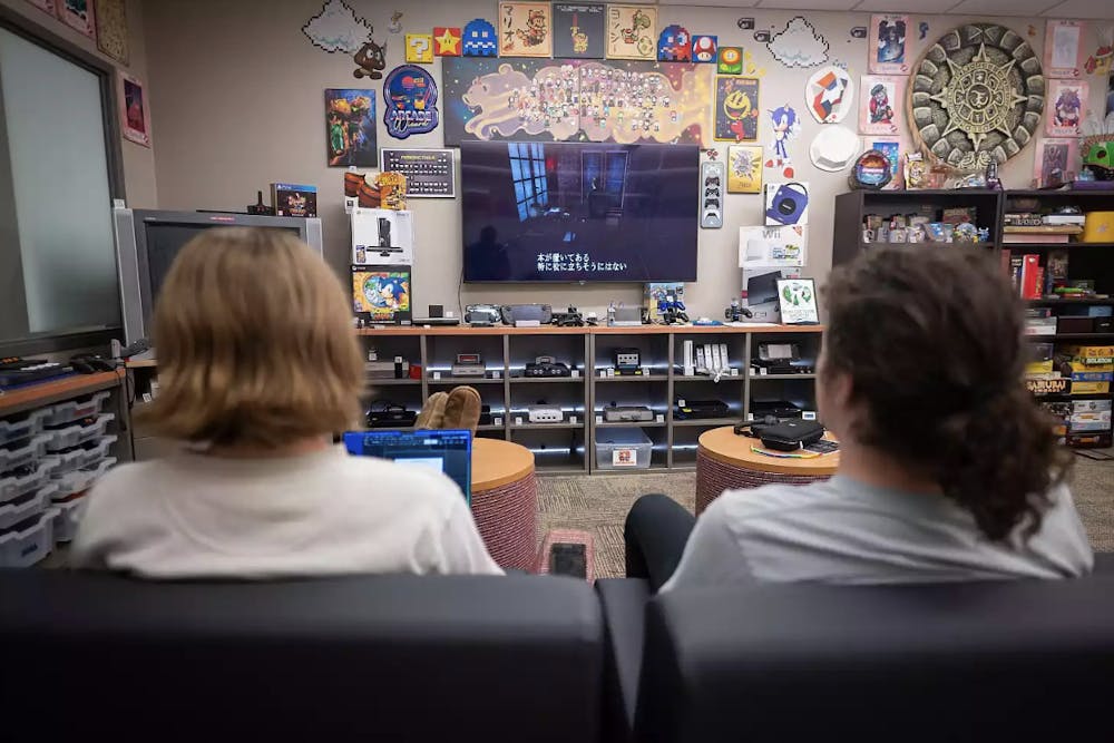 Two students play a video game inside MARLA. There are two TVs in MARLA - the TV on the left seems to just mainly play retro TV shows/commercials. (Photo Courtesy of Alex Kumar/Indiana University)