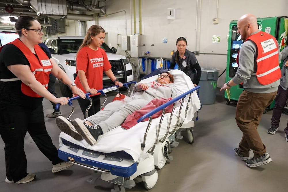 In the ambulance bay at Eskenazi Hospital, a student doctor shares information about her mock patient during a collaborative simulation training. (Photo courtesy of Tim Yates/IU School of Medicine)