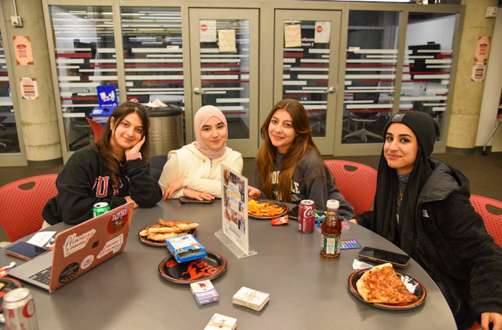 <p>Students sit together at a Stress Busters Week event in Fall 2022. Image courtesy of the Health and Wellness Promotion.</p>