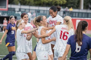 Cassie Rodriguez, Sam Slimak, and others embrace with Kailyn Smith who just scored