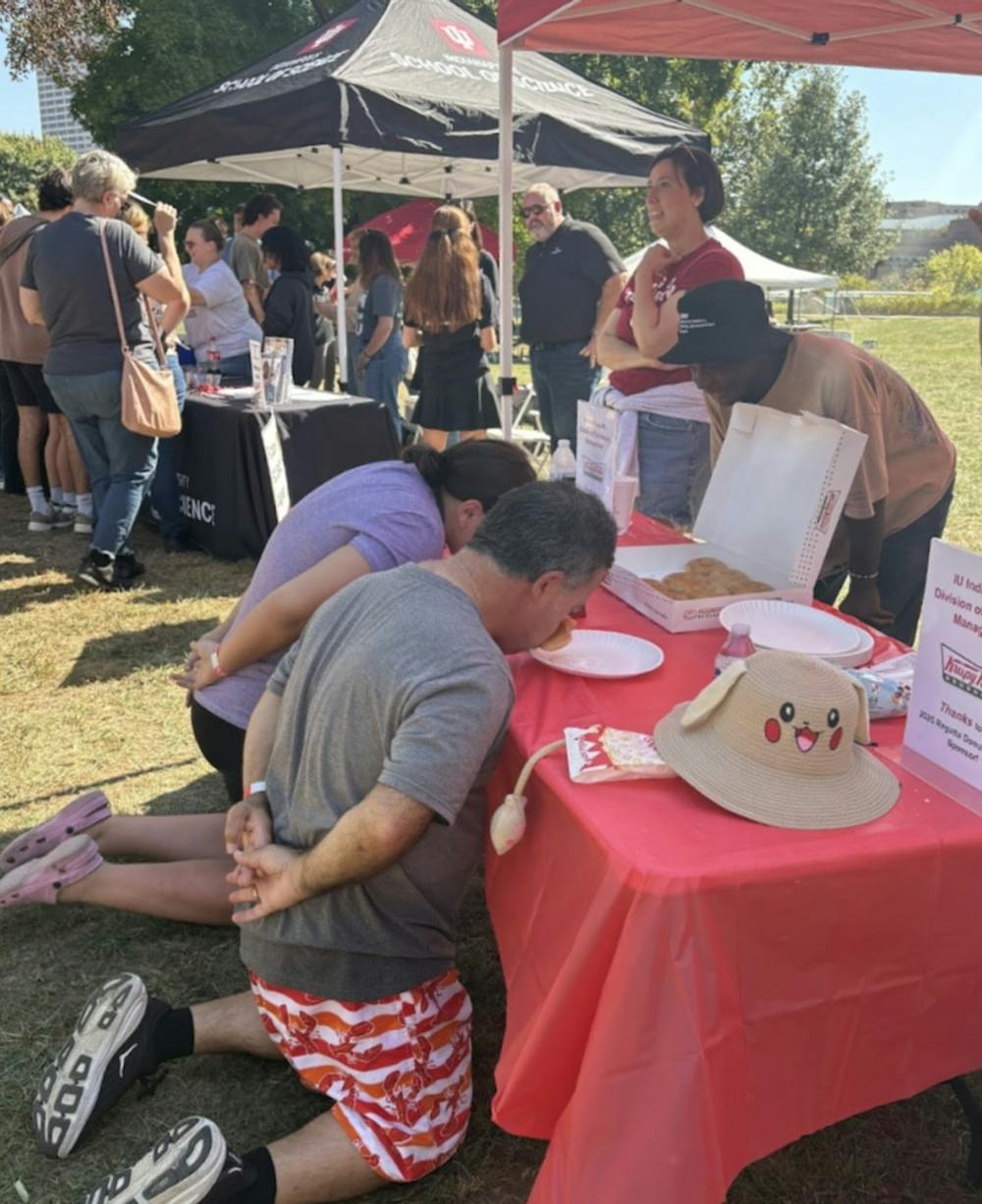 Politis (right) and Fleet (left) compete in the no-hands eating contest at Regatta. 