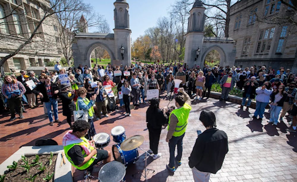 Hundreds gather for a rally in support of international graduate rights at the Sample Gates in IU Bloomington  on Thursday, April 10, 2025. Photo Credit: The Herald Times
