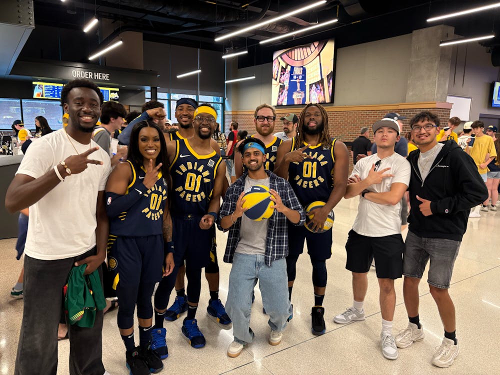 Franck Jeufack (left), Hitten Vasnani (middle left), Eddie Hill (middle right), and Alex Cuevas (right) pose with the Pacers Power Pack in the Gainbridge Fieldhouse concourse. Photo Credit: Alex Cuevas