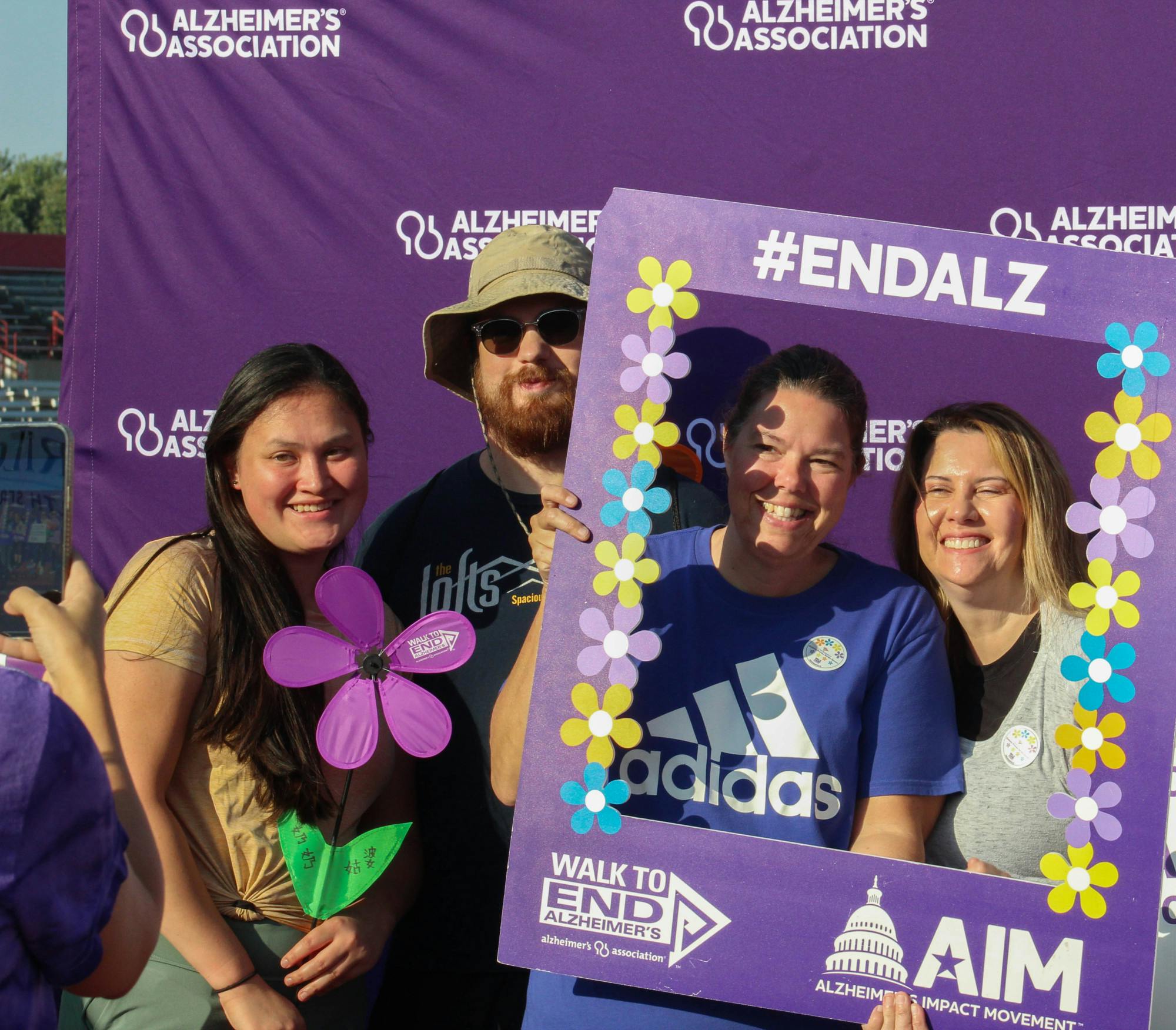 Attendees pose at the Alzheimer's Association photo booth