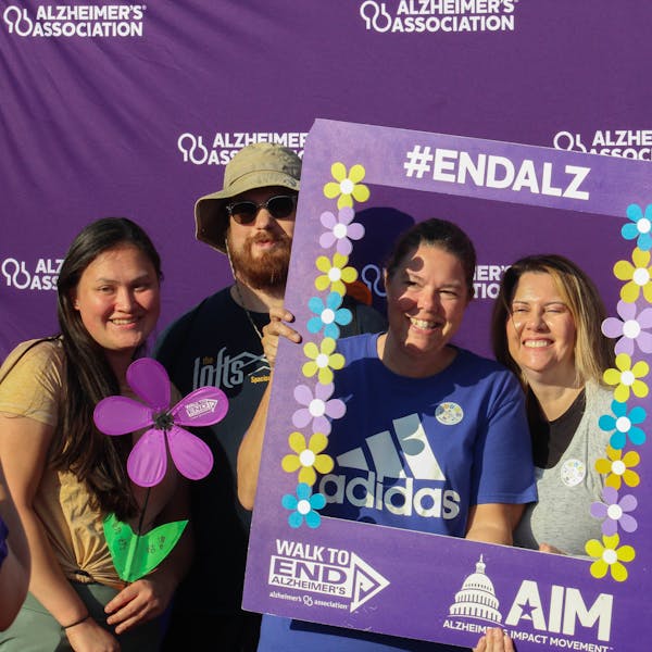 Attendees pose at the Alzheimer's Association photo booth