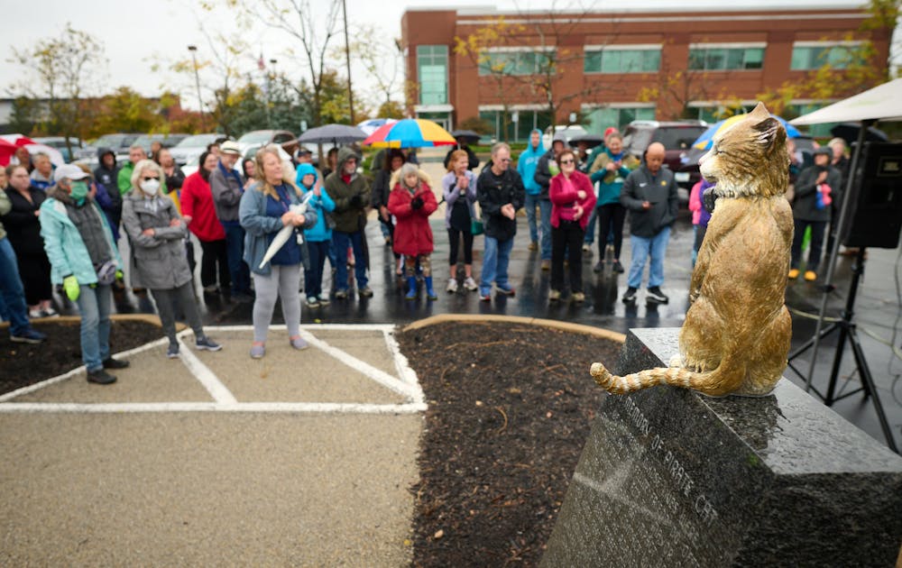 Friends brave the rain to pay to honor Pirate Cat.