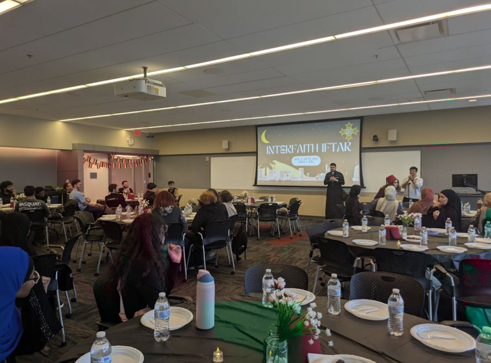 Mostafa Abdulaleem, member of Muslim Student Association, welcomes the attendees to the interfaith iftar event.