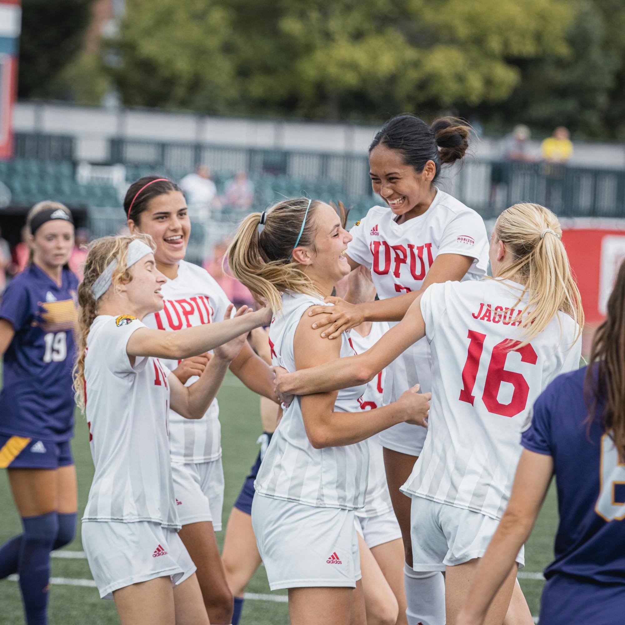 Cassie Rodriguez, Sam Slimak, and others embrace with Kailyn Smith who just scored