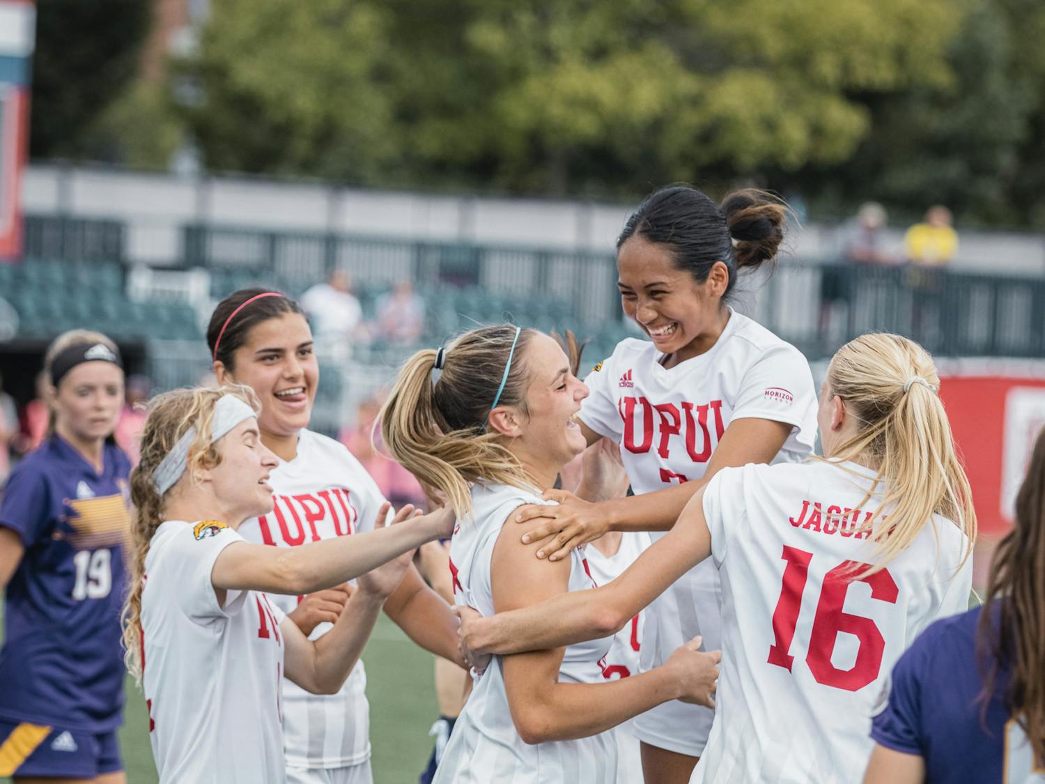 Cassie Rodriguez, Sam Slimak, and others embrace with Kailyn Smith who just scored