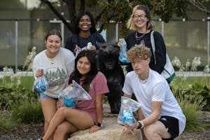 Students pose with their completed shirts in the Tower Courtyard