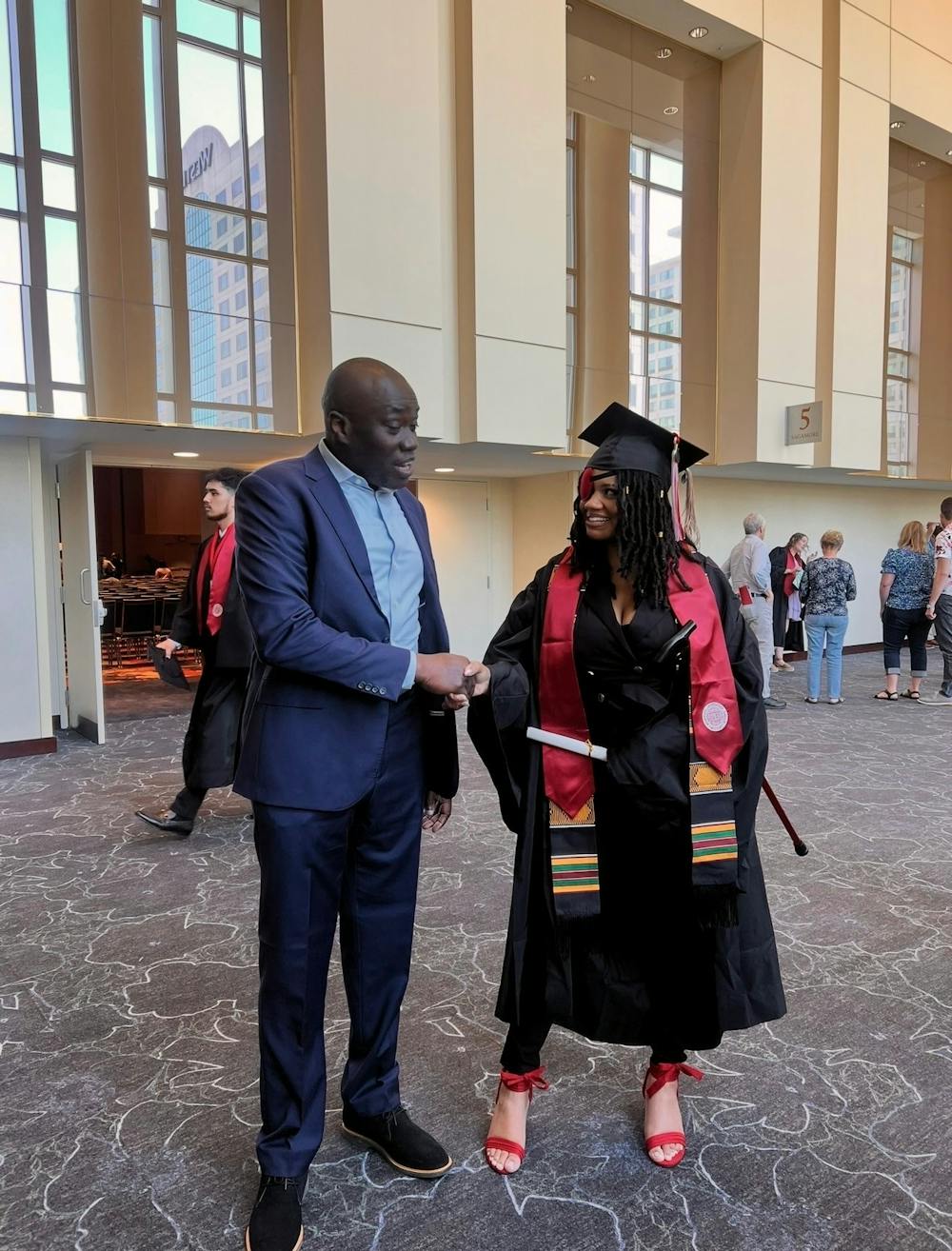 Troi Wharton poses with her father after earning her Kelley School of Business Indianapolis degree in May 2026, years after watching him graduate from Kelley. (Photo courtesy of Troi Wharton)