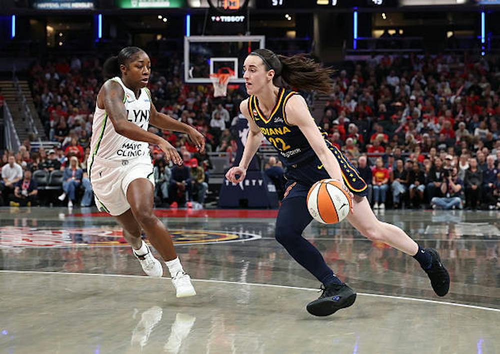Indiana Fever guard Caitlin Clark (No. 22) dribbles as Minnesota Lynx’s guard Aari McDonald (No. 4) defends. (Photo courtesy of Andy Lyons/Getty Images)